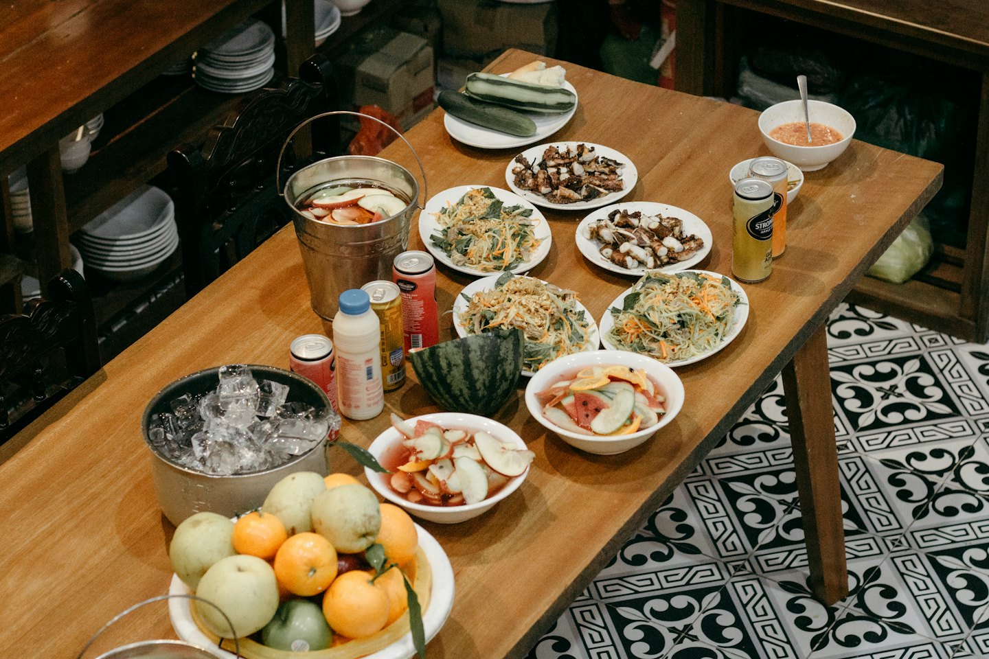 Rustic table spread with salads, grilled octopus, and fresh fruit.